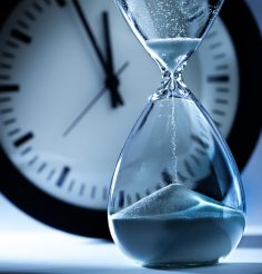 deadline-and-out-of-time-sand-timer-hourglass-and-clock-at-midnight-picture-id867550598